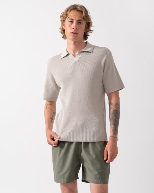 Model wearing a BOSS Orange Aravolo Mens Short Sleeve Knit Polo Shirt in Open Grey 070