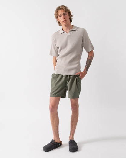 full length shot of a Model wearing a BOSS Orange Aravolo Mens Short Sleeve Knit Polo Shirt in Open Grey 070