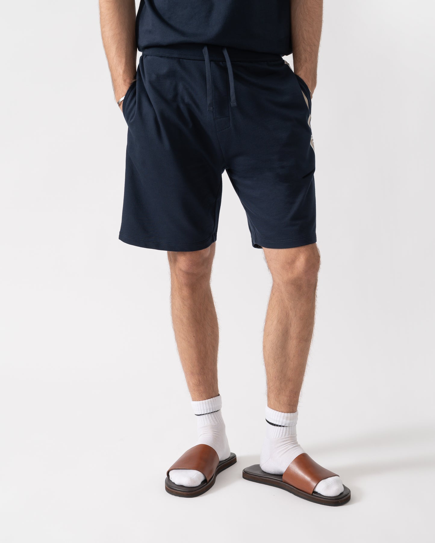 model wearing a BOSS Orange Authentic Mens Loungewear Shorts with Stripe and Logo in Dark Blue 405