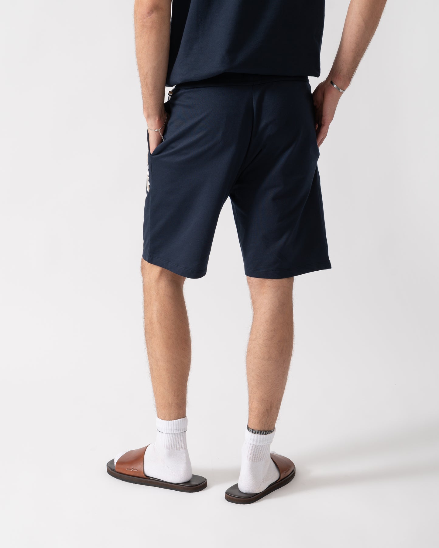 back of a model wearing a BOSS Orange Authentic Mens Loungewear Shorts with Stripe and Logo in Dark Blue 405