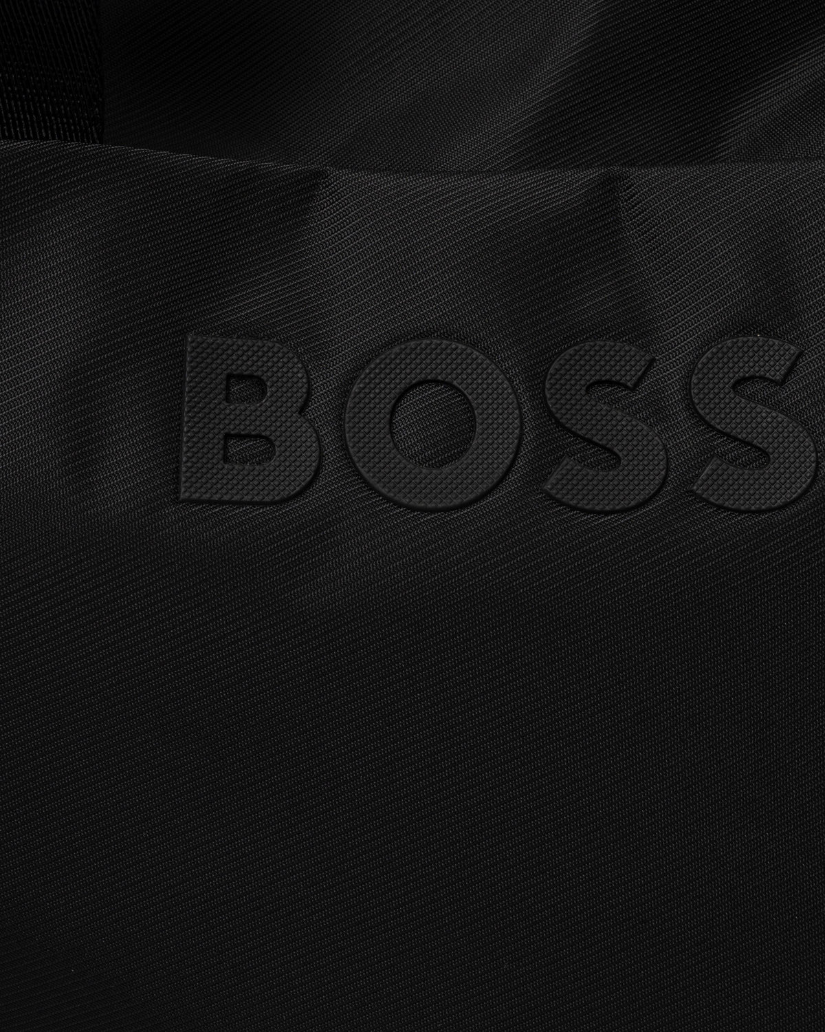 Very close up of the BOSS Orange Catch 3.0 Mens Holdall 50567750 - Black 001