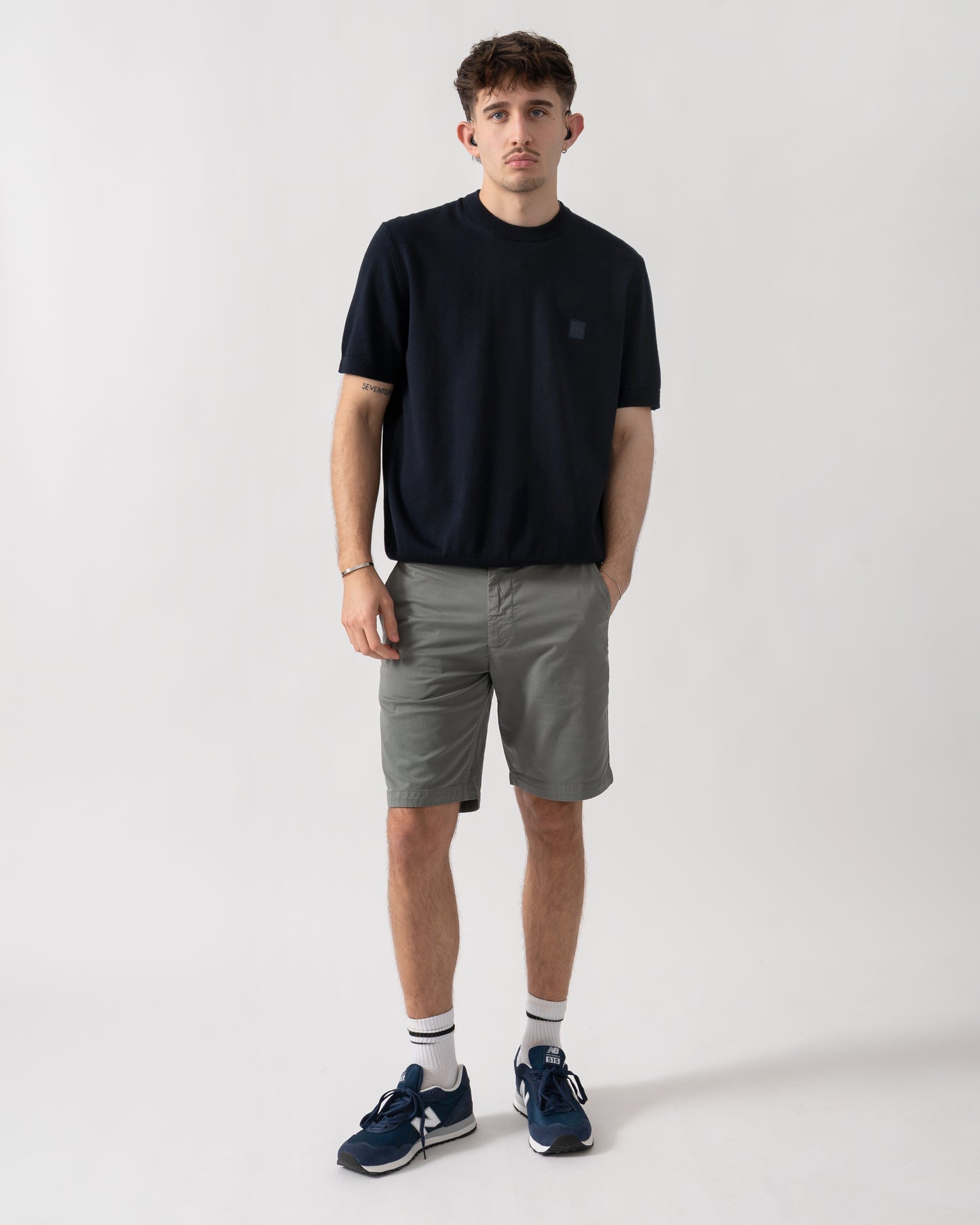 full length studio shot of a model wearing a BOSS Orange Kanacho Mens T-Shirt in Dark Blue 404