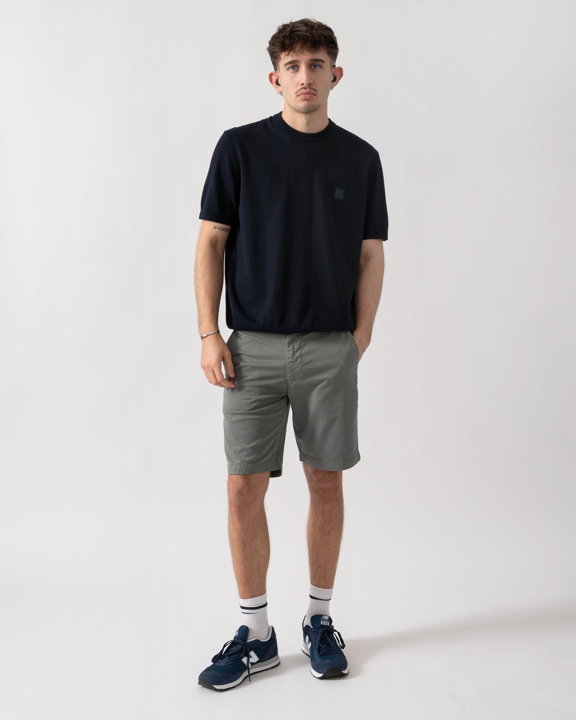 full length studio shot of a model wearing a BOSS Orange Kanacho Mens T-Shirt in Dark Blue 404
