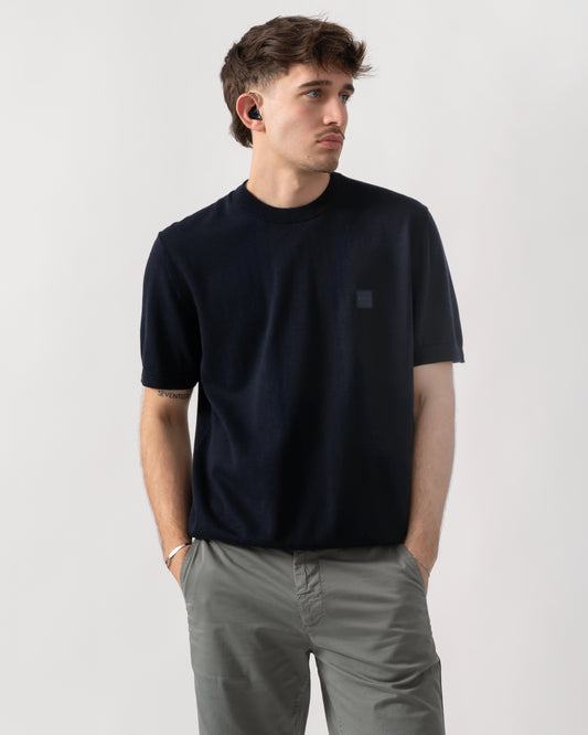 studio shot of a model wearing a BOSS Orange Kanacho Mens T-Shirt in Dark Blue 404