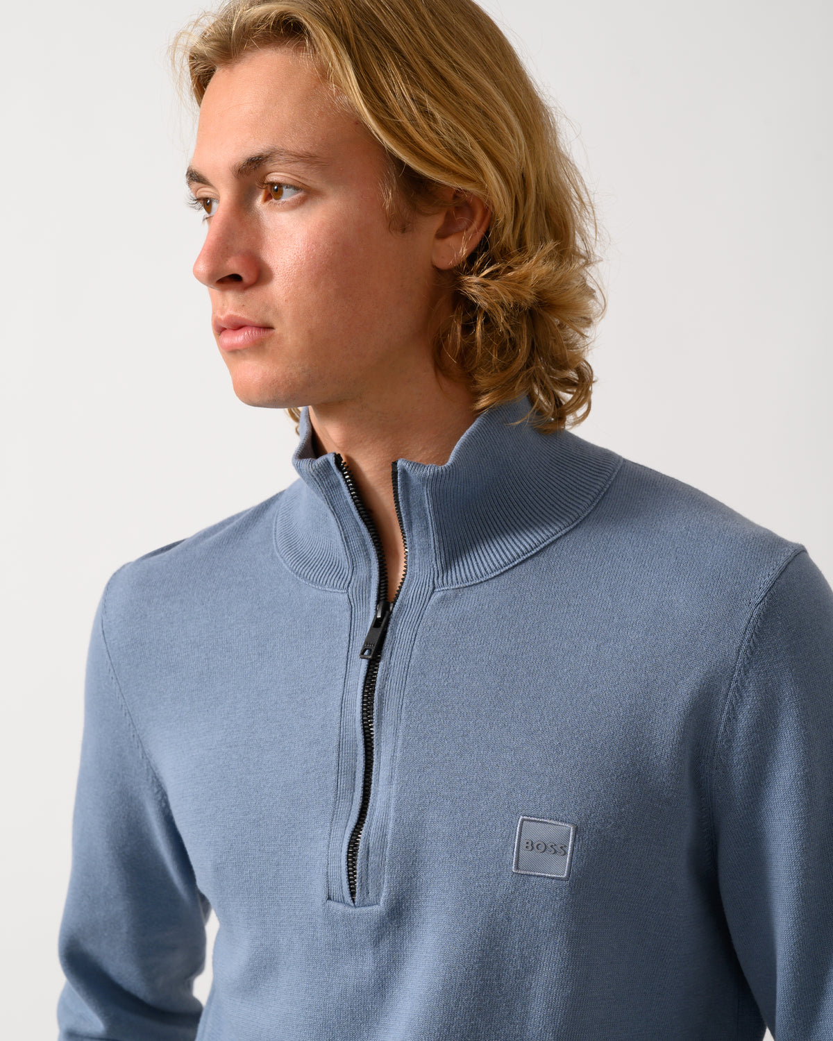 close up of model wearing a BOSS Orange Kanobix S Mens 1/4 Zip Jumper in Medium Blue 424