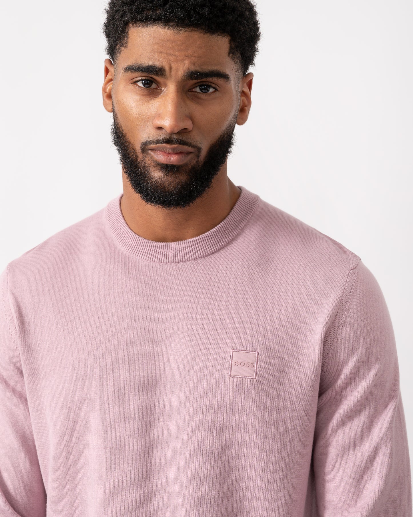 close up of a model wearing a BOSS Orange Kanovano Mens Crew Neck Jumper in Light Pastel Purple