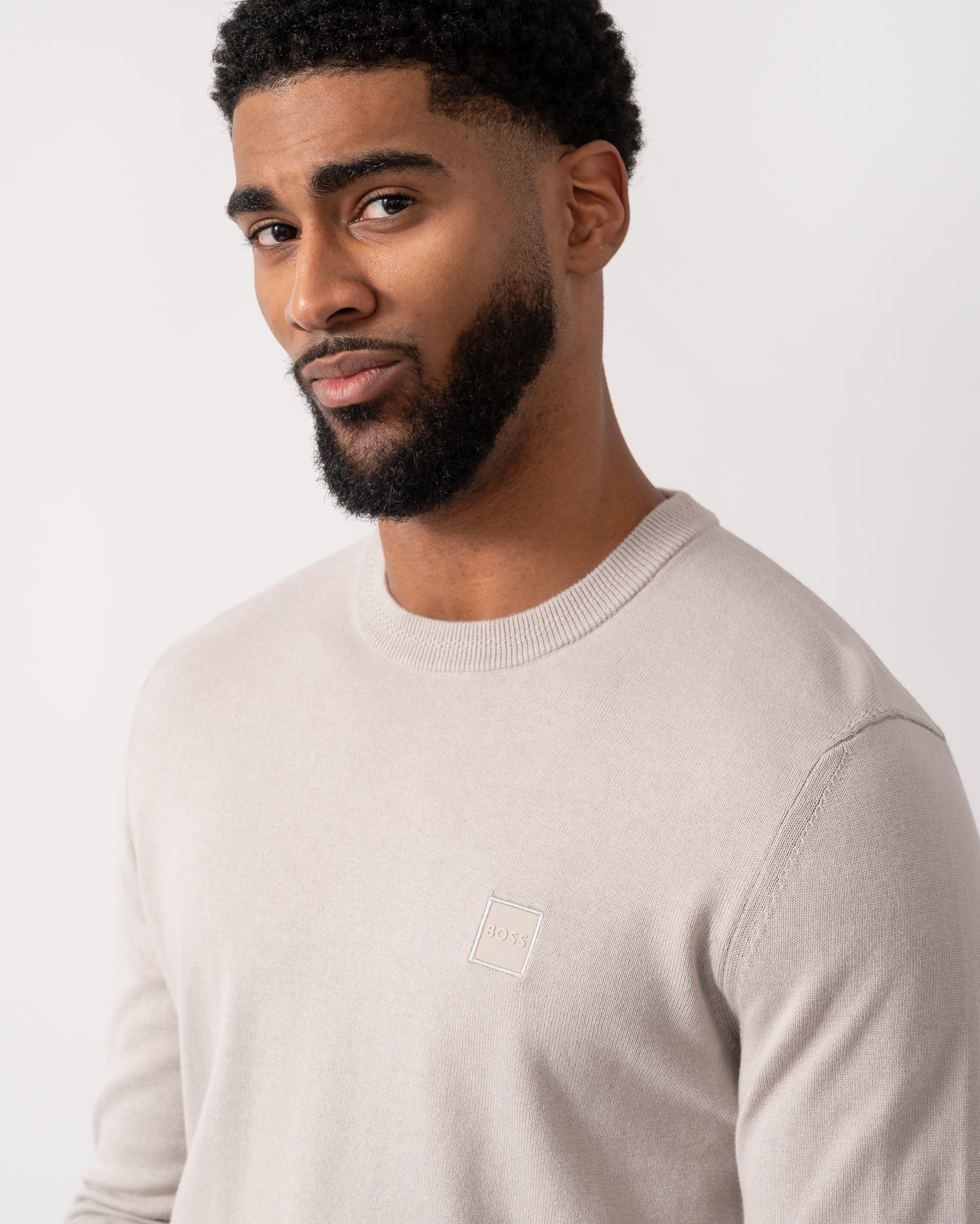 detail shot of a model wearing a BOSS Orange Kanovano Mens Crew Neck Jumper in Open Grey