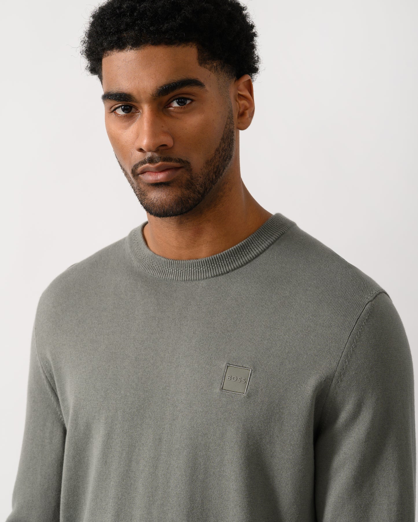 close up shot of a model wearing a BOSS Orange Kanovano Mens Crew Neck Jumper in Open Grey 076