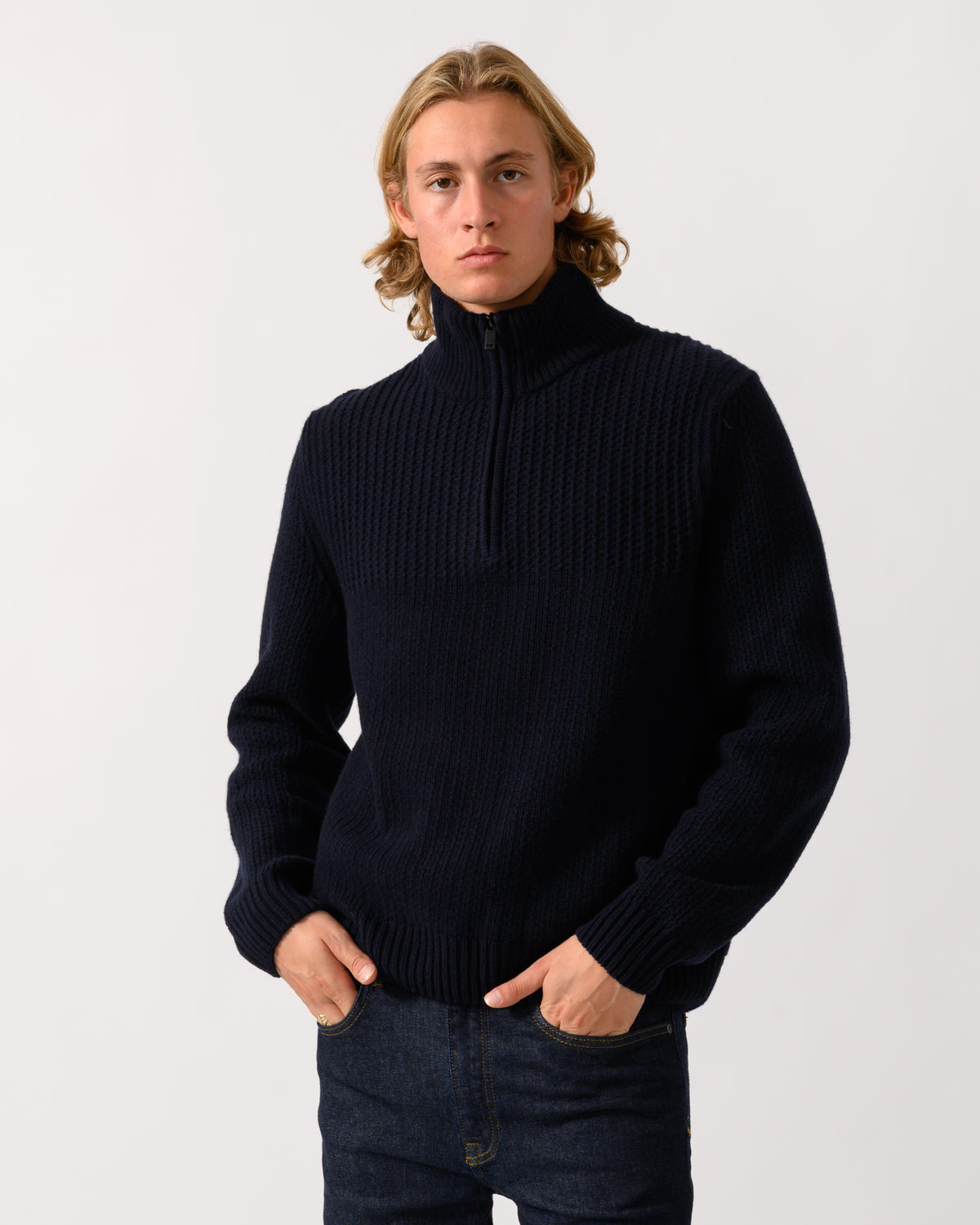 model wearing a BOSS Orange Kenter Mens 1/4 Zip Funnel Neck Jumper in Dark Blue 404