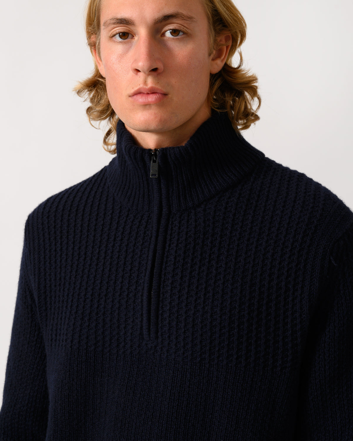 close up of model wearing a BOSS Orange Kenter Mens 1/4 Zip Funnel Neck Jumper in Dark Blue 404