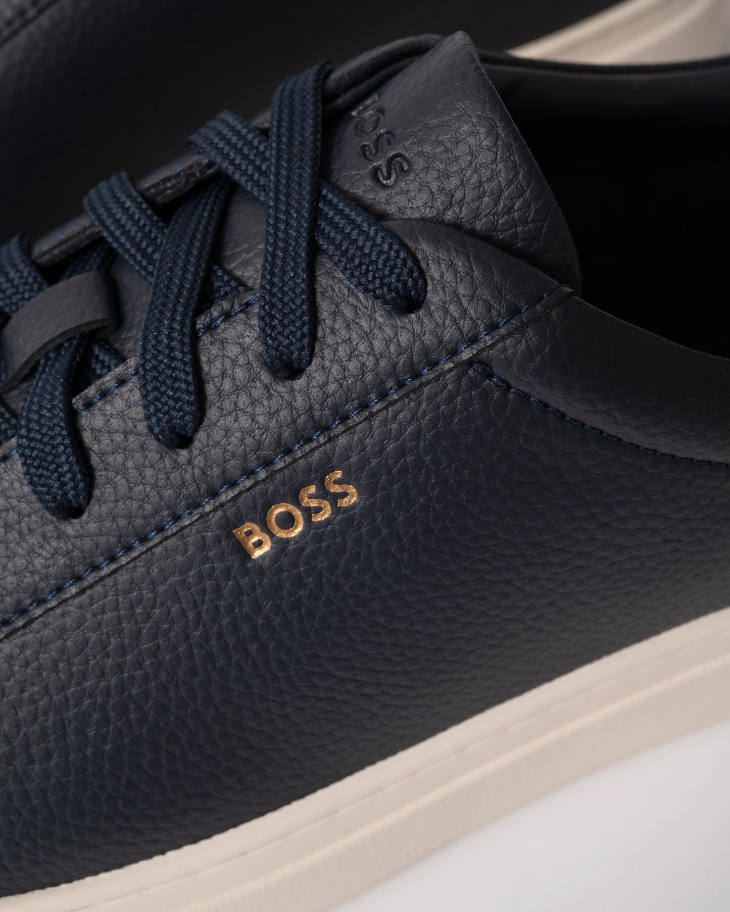 close up view of BOSS Orange Kieran Mens Grained-leather trainers with rubber sole in Dark Blue 407