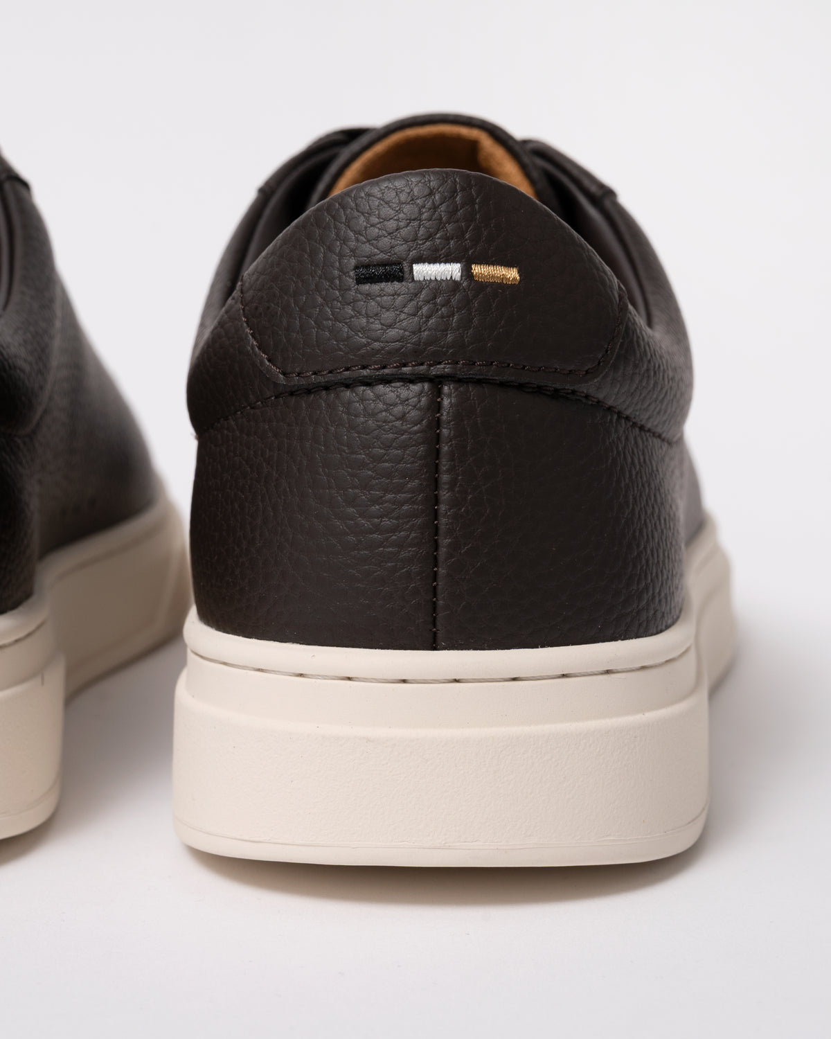 Studio photograph showing back of BOSS Orange Kieran Mens Grained-leather trainers with rubber sole in Dark Brown 203