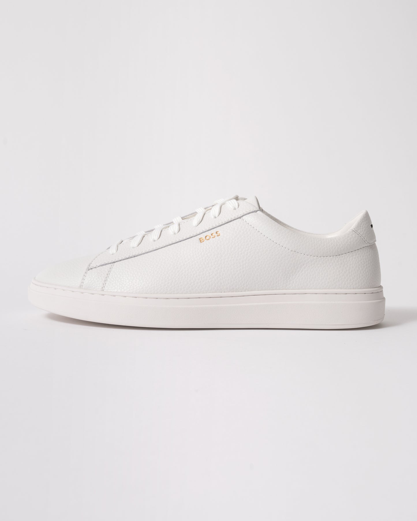 side studio shot of BOSS Orange Kieran Mens Grained-leather trainers with rubber sole in White 100
