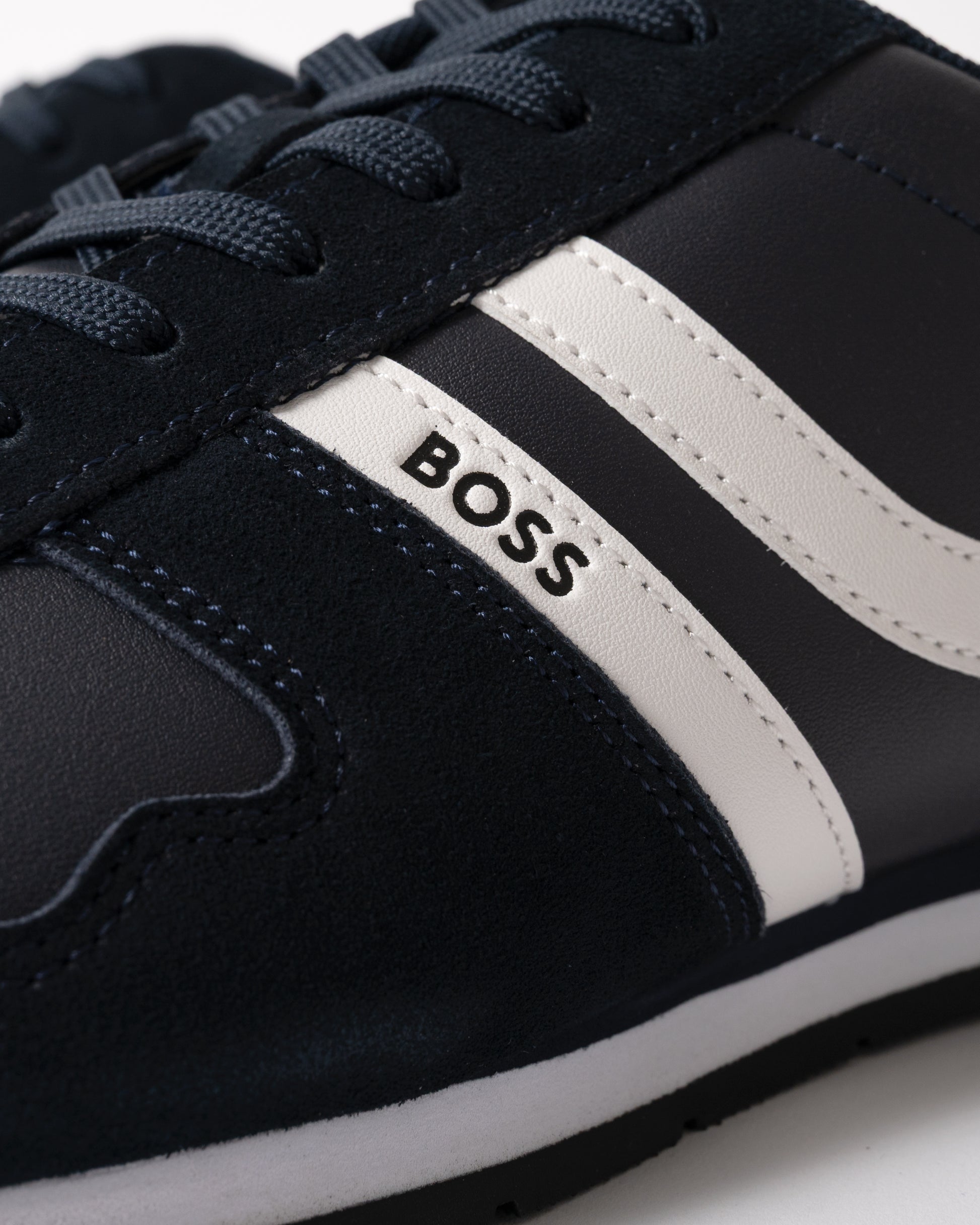 close up studio shot of BOSS Orange Levon Runn pumi Mens Trainers in Dark Blue 401