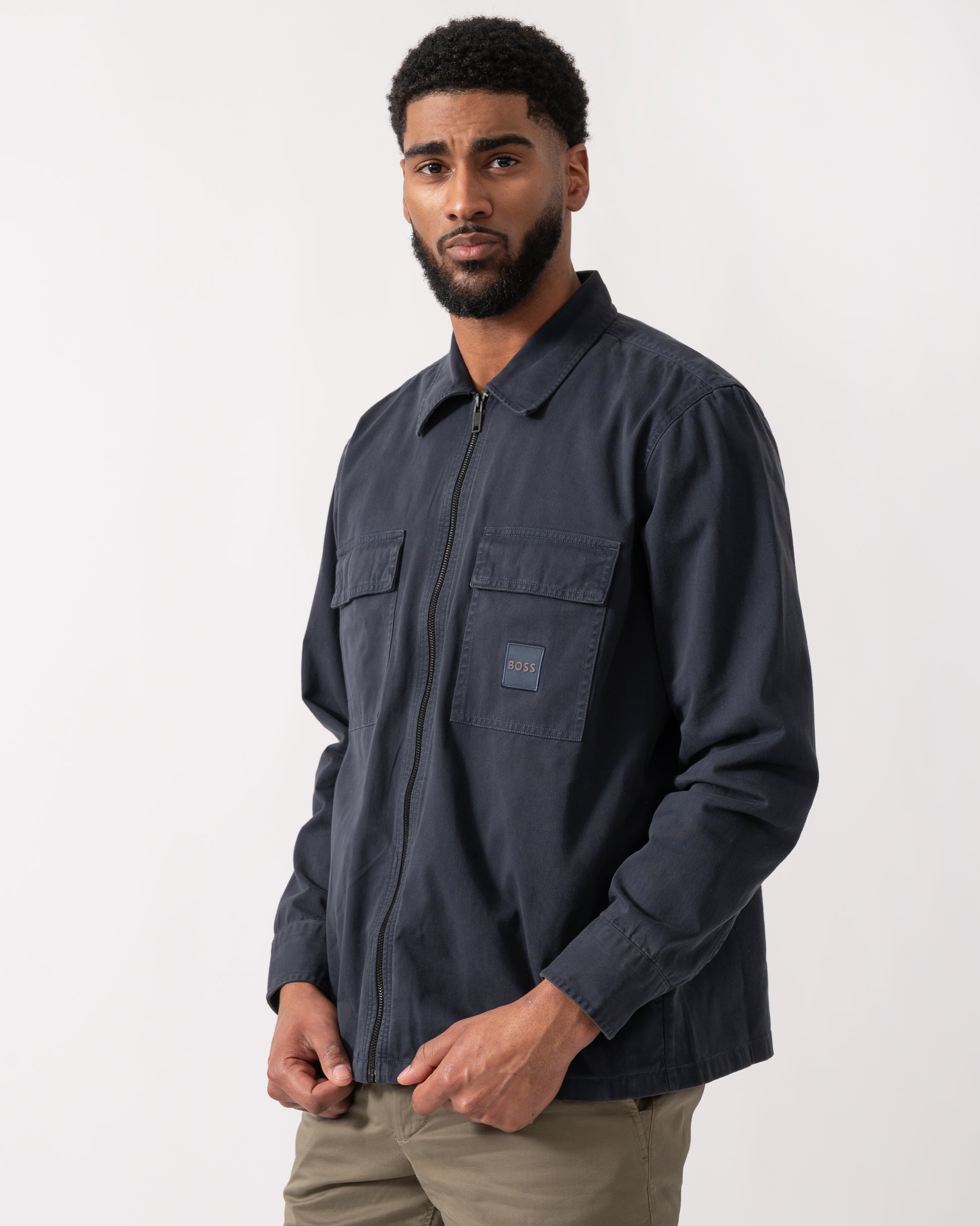 mid shot of a model wearing a BOSS Orange Lovel Mens Zip Overshirt in Dark Blue