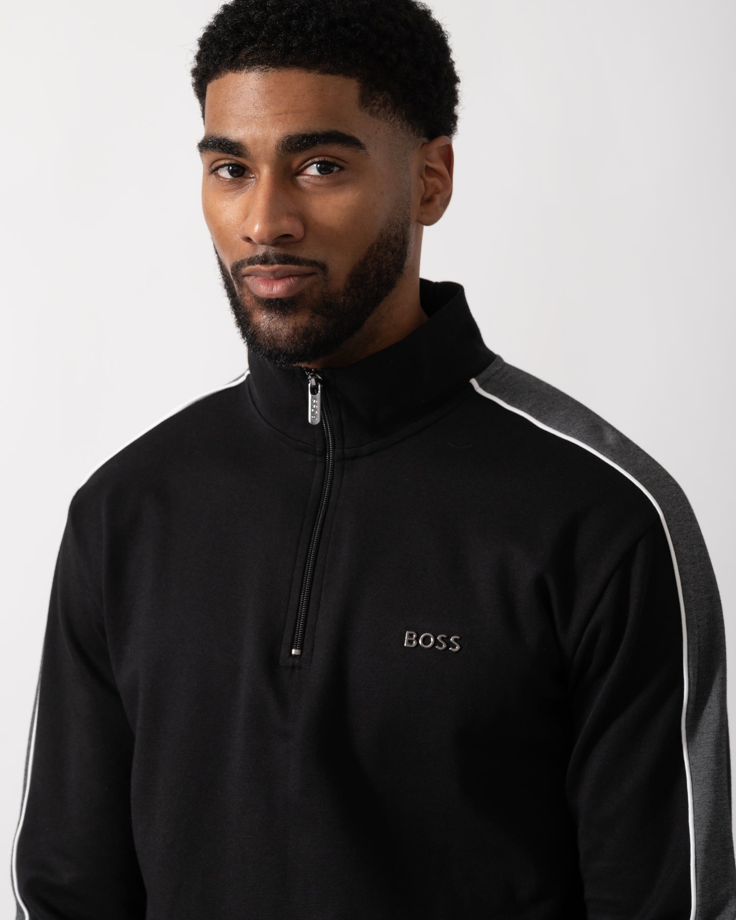 Close up shot of a Model wearing a BOSS Orange Mens 1/4 Zip Loungewear Tracksuit Jacket in Black