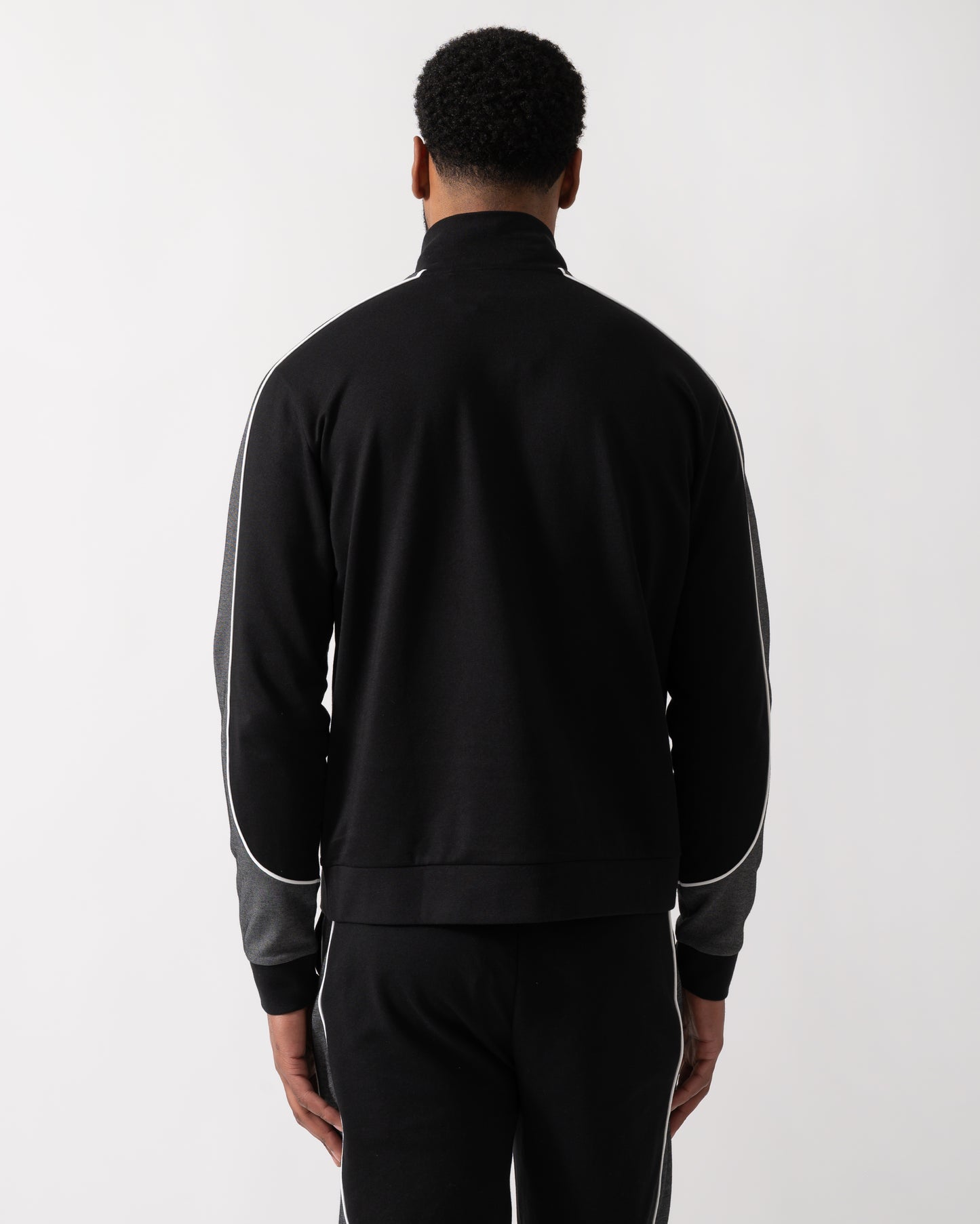 Back shot of a Model wearing a BOSS Orange Mens 1/4 Zip Loungewear Tracksuit Jacket in Black