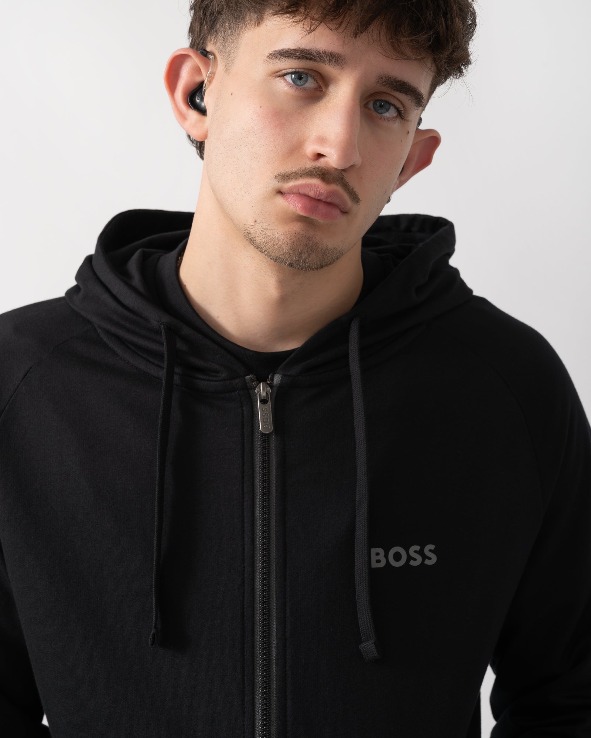 close up shot of a model wearing a BOSS Orange Mens Authentic Zip Up Loungewear Hoodie in Black 004