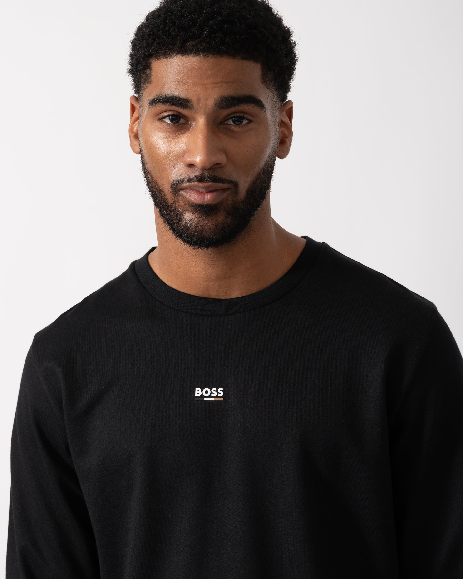 Close up shot of a Model wearing a BOSS Orange Mens Iconic Loungewear Sweatshirt in Black
