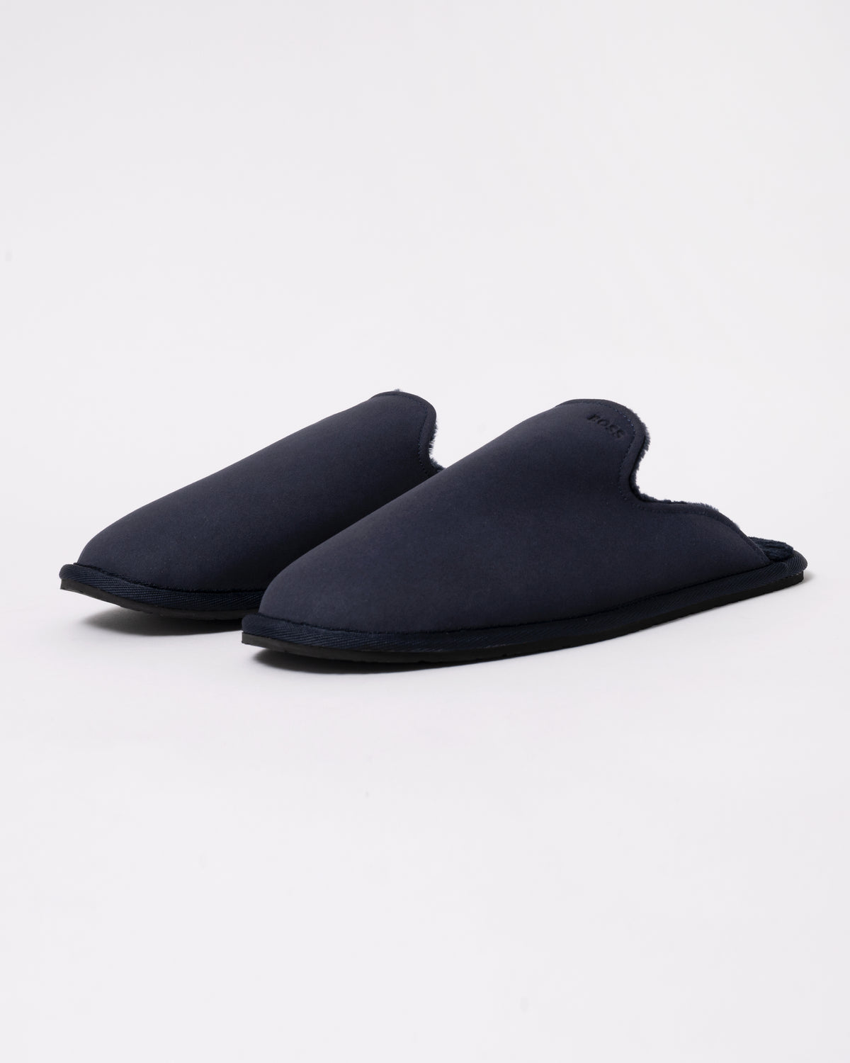 Studio photograph of BOSS Orange Mens Shearling-lined slip-on slippers with logo detail in Dark Blue 404
