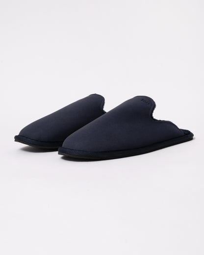 Studio photograph of BOSS Orange Mens Shearling-lined slip-on slippers with logo detail in Dark Blue 404