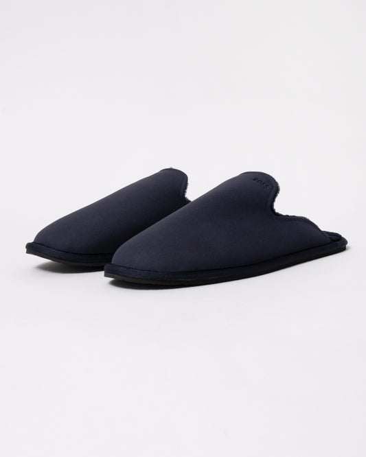 Studio photograph of BOSS Orange Mens Shearling-lined slip-on slippers with logo detail in Dark Blue 404