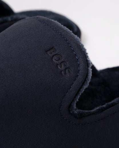close up Studio photograph of BOSS Orange Mens Shearling-lined slip-on slippers with logo detail in Dark Blue 404