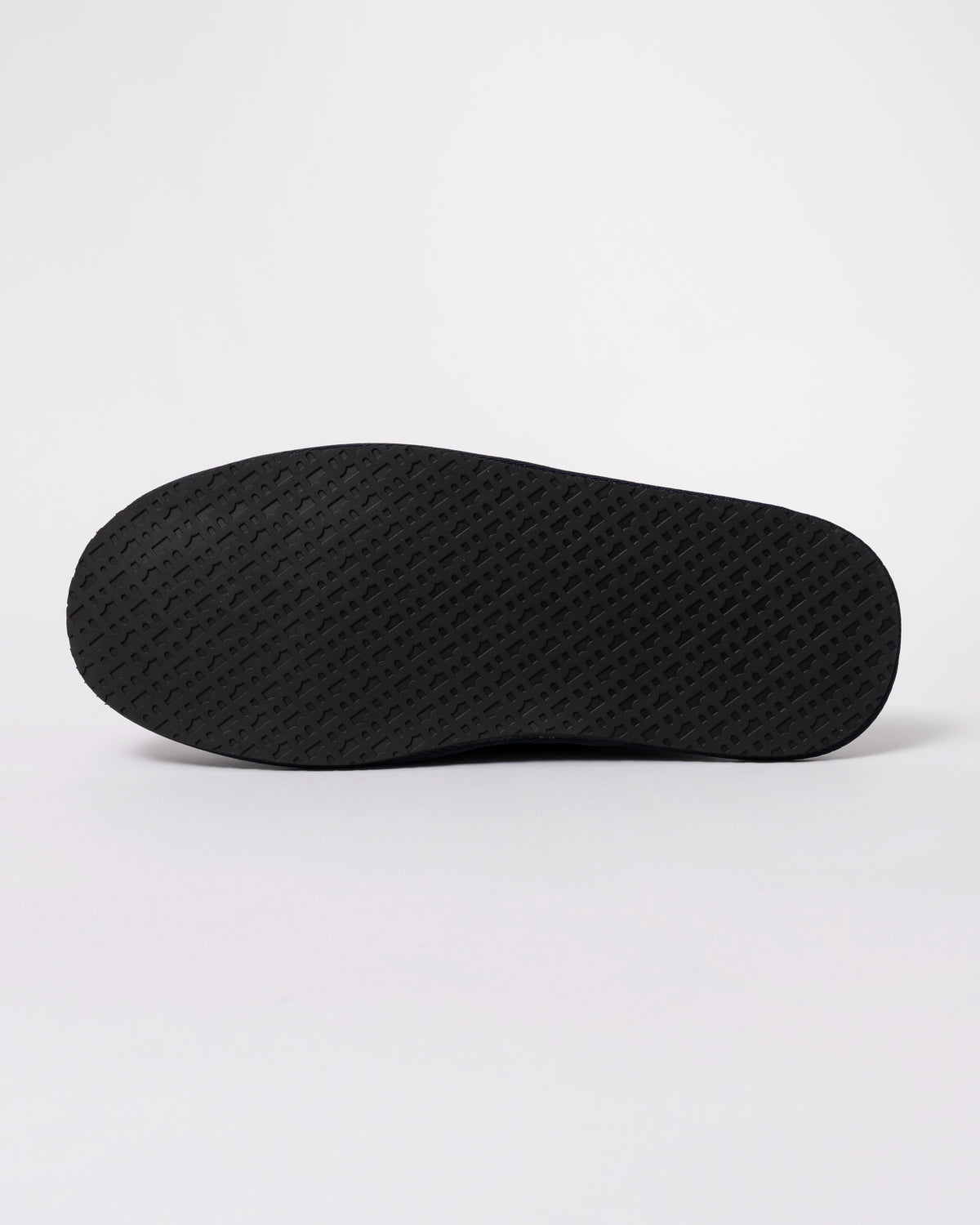 Studio photograph showing sole of BOSS Orange Mens Shearling-lined slip-on slippers with logo detail in Dark Blue 404