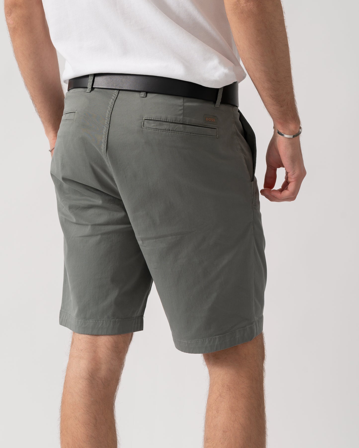 back shot of a model wearing a pair of BOSS Orange Mens Slim Fit Chino Shorts in Stretch Cotton Twill in Open Grey 076