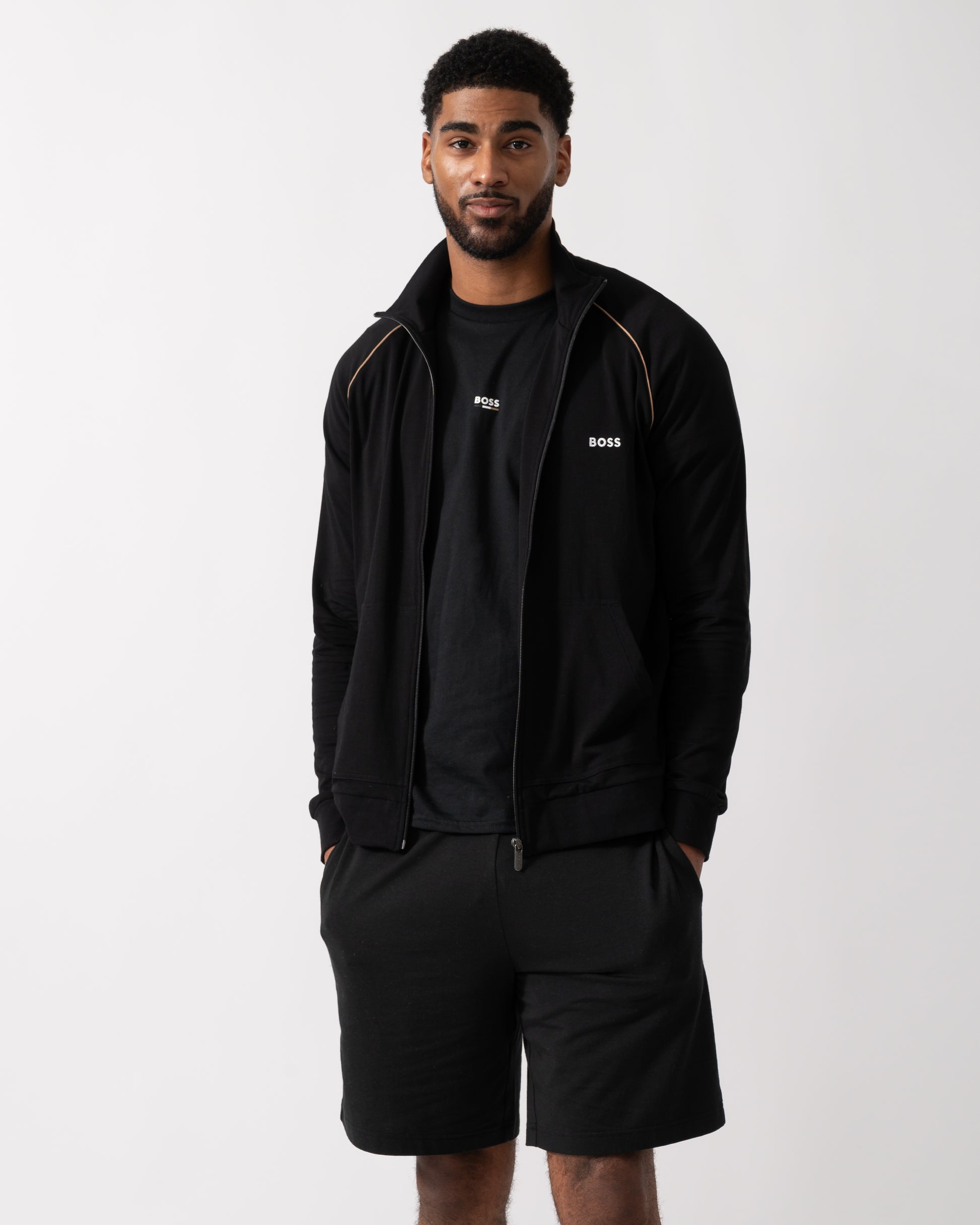 Model wearing a BOSS Orange Mix&Match Mens Logo-Embroidered Full Zip Loungewear Jacket in black Stretch-Cotton Jersey