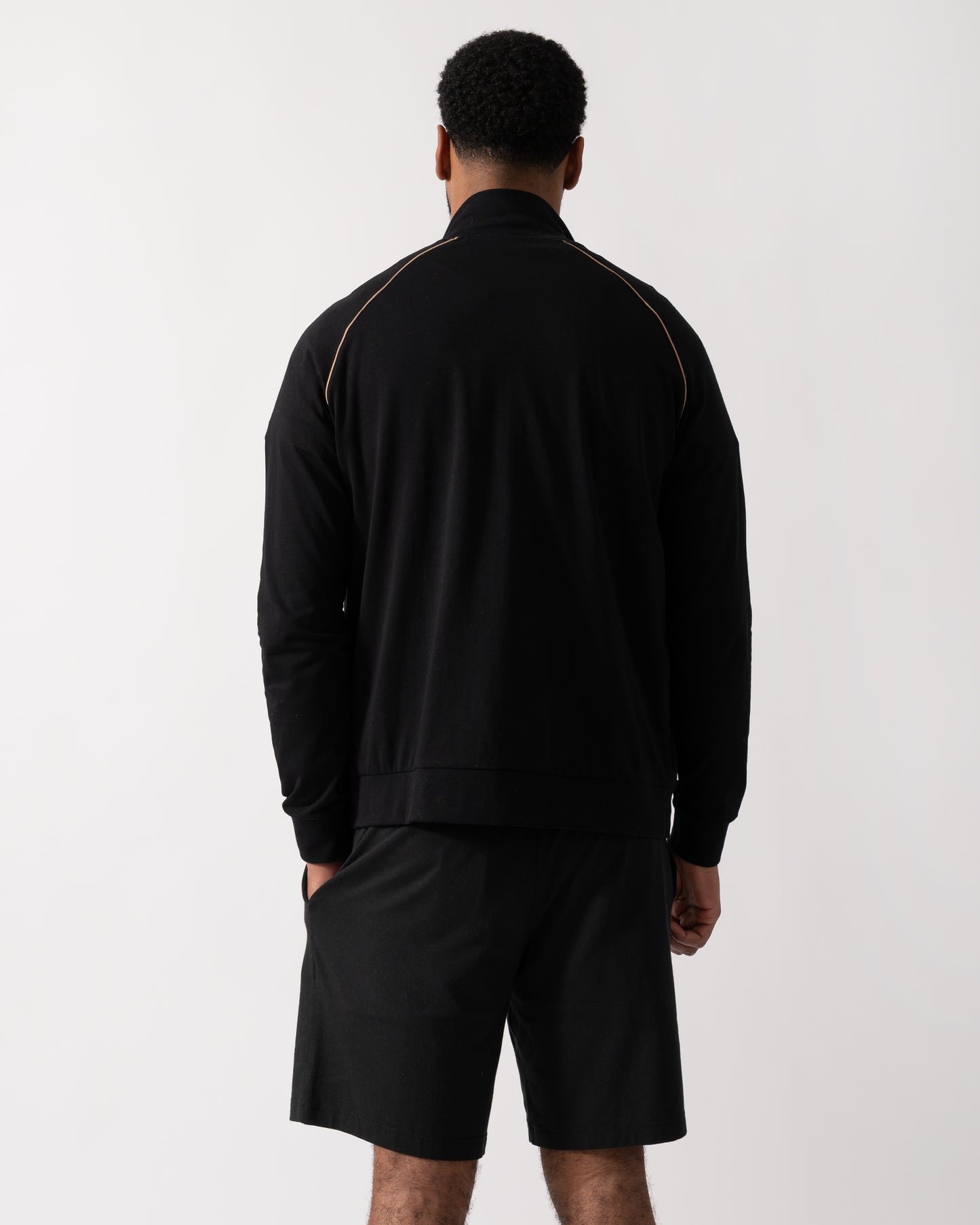 Back shot of a Model wearing a BOSS Orange Mix&Match Mens Logo-Embroidered Full Zip Loungewear Jacket in black Stretch-Cotton Jersey