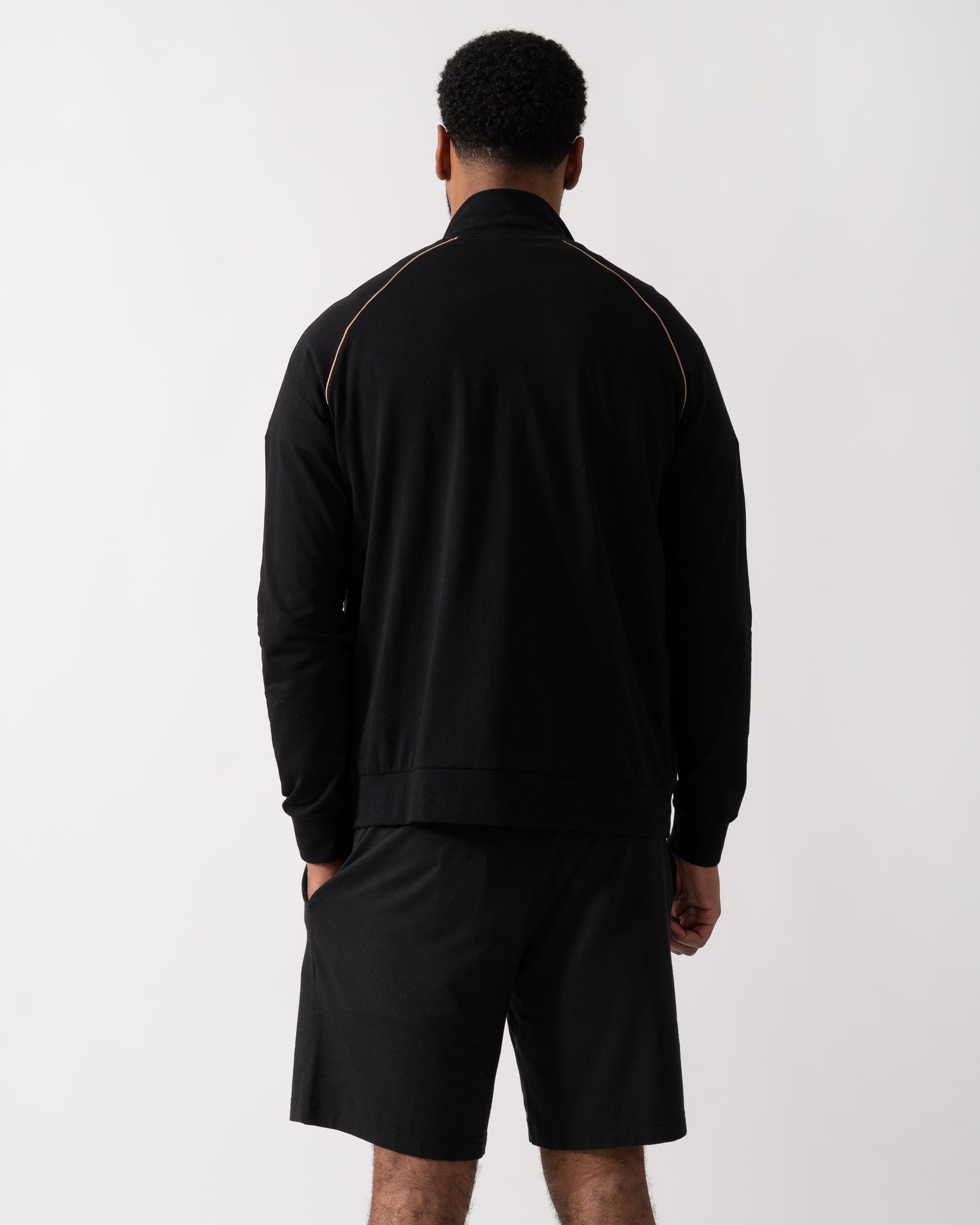 Back shot of a Model wearing a BOSS Orange Mix&Match Mens Logo-Embroidered Full Zip Loungewear Jacket in black Stretch-Cotton Jersey