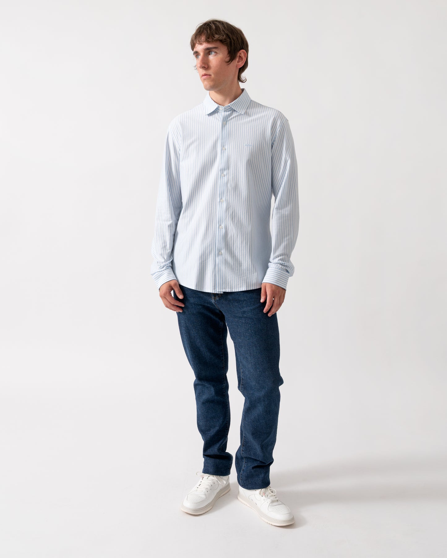 full length of a model wearing a BOSS Orange Mysoft Mens Slim-Fit Shirt in Melange Cotton Jersey in Open Blue 461