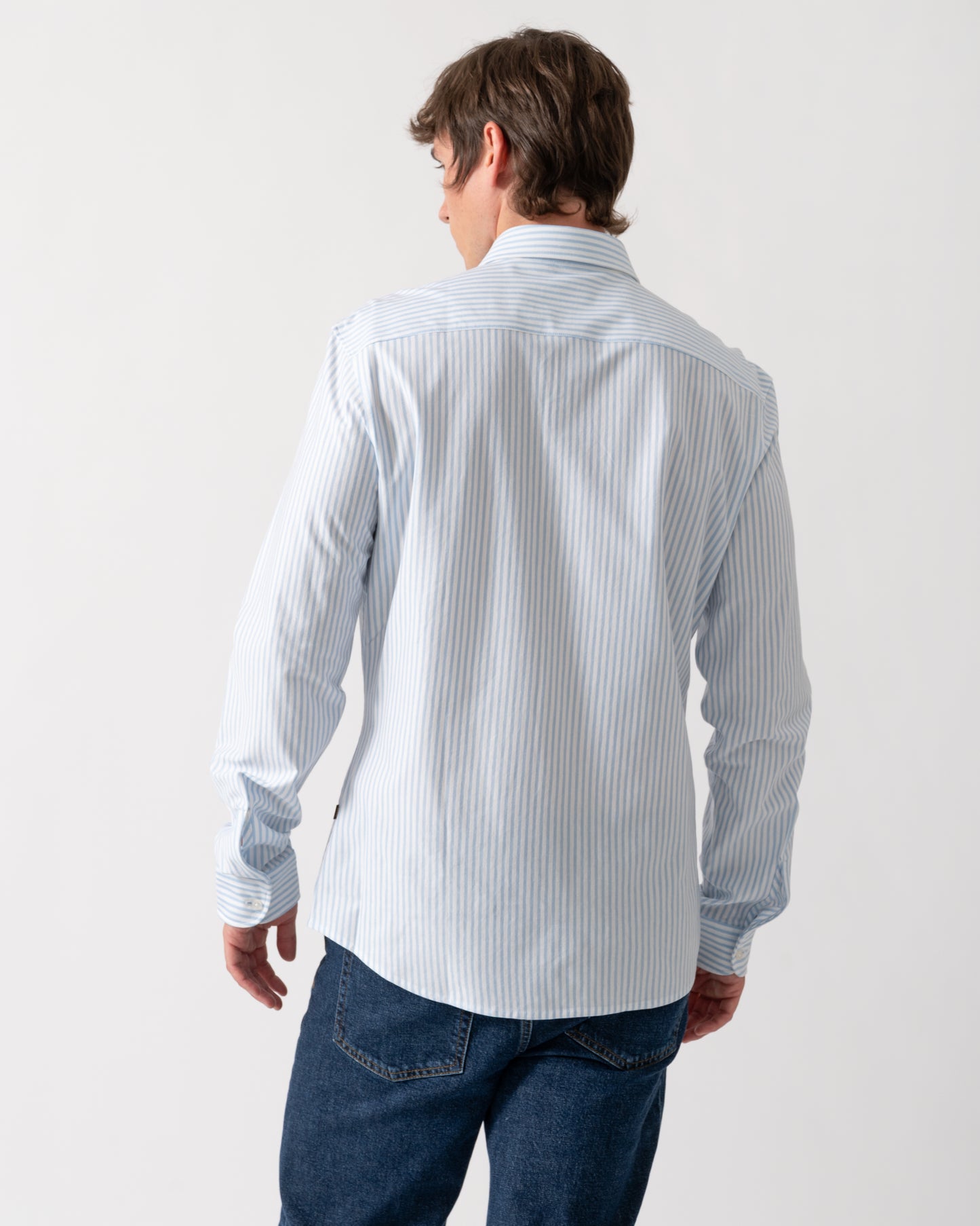 back of a model wearing a BOSS Orange Mysoft Mens Slim-Fit Shirt in Melange Cotton Jersey in Open Blue 461