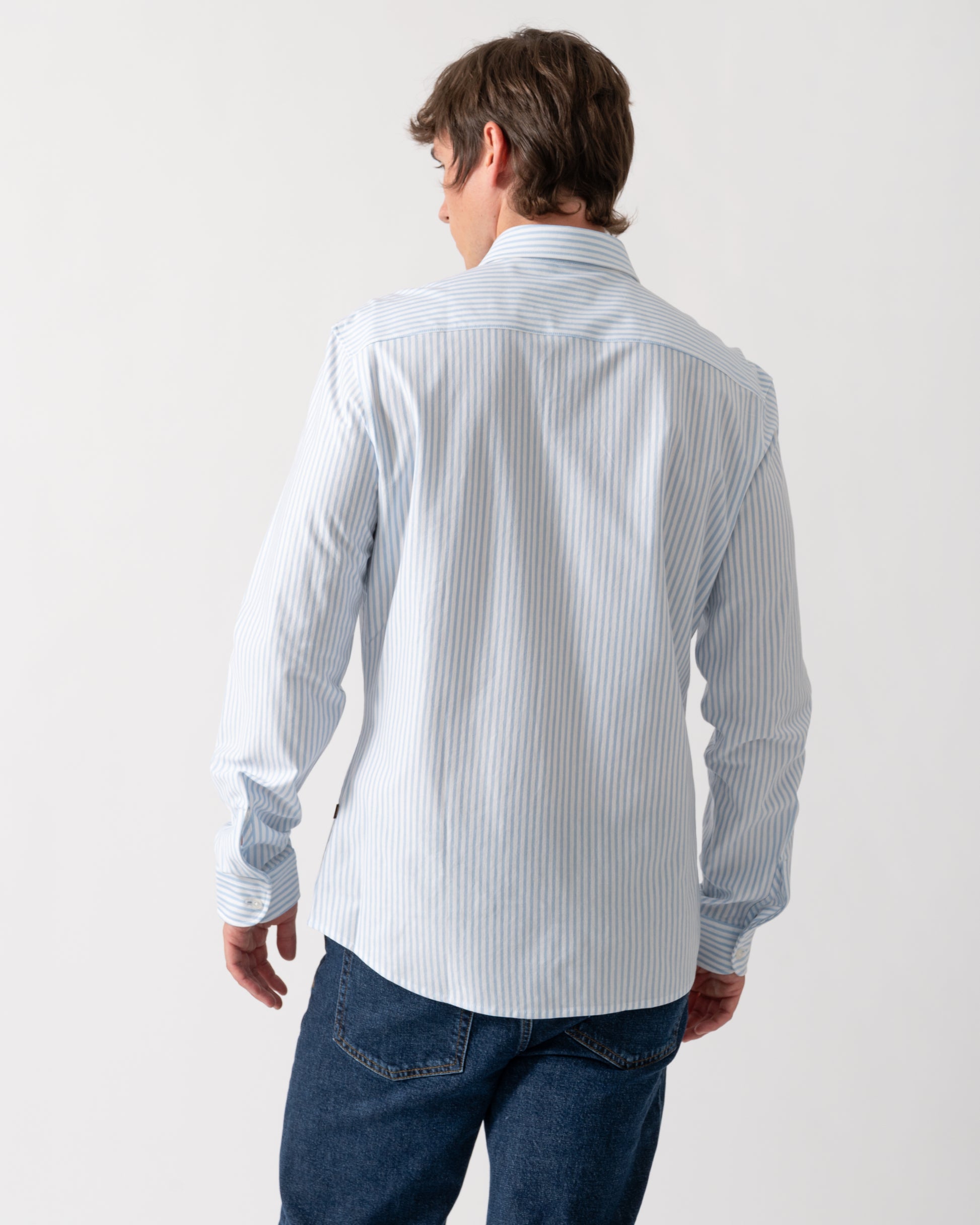 back of a model wearing a BOSS Orange Mysoft Mens Slim-Fit Shirt in Melange Cotton Jersey in Open Blue 461