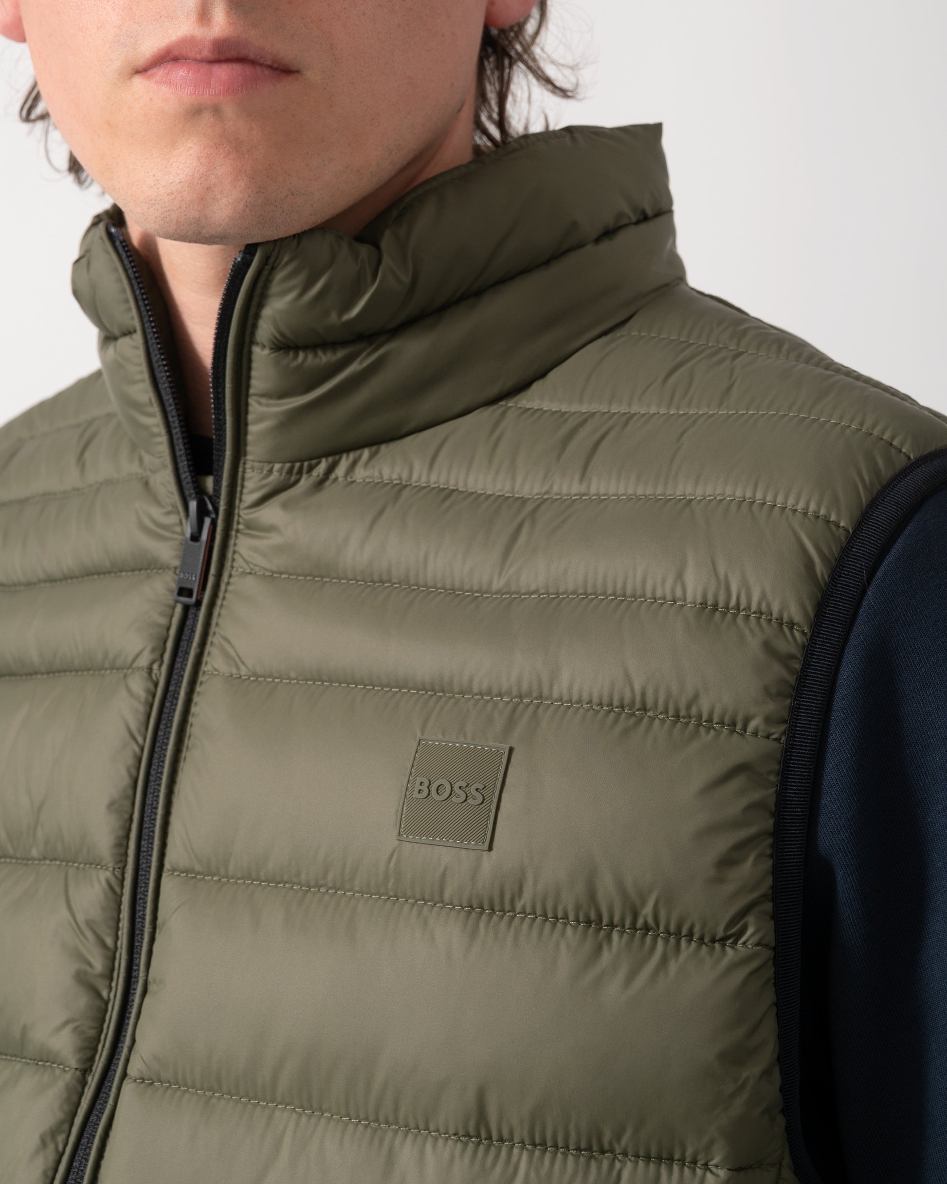 detail shot of a model wearing a BOSS Orange Odeno 2 Mens Gilet in Bright Green 325
