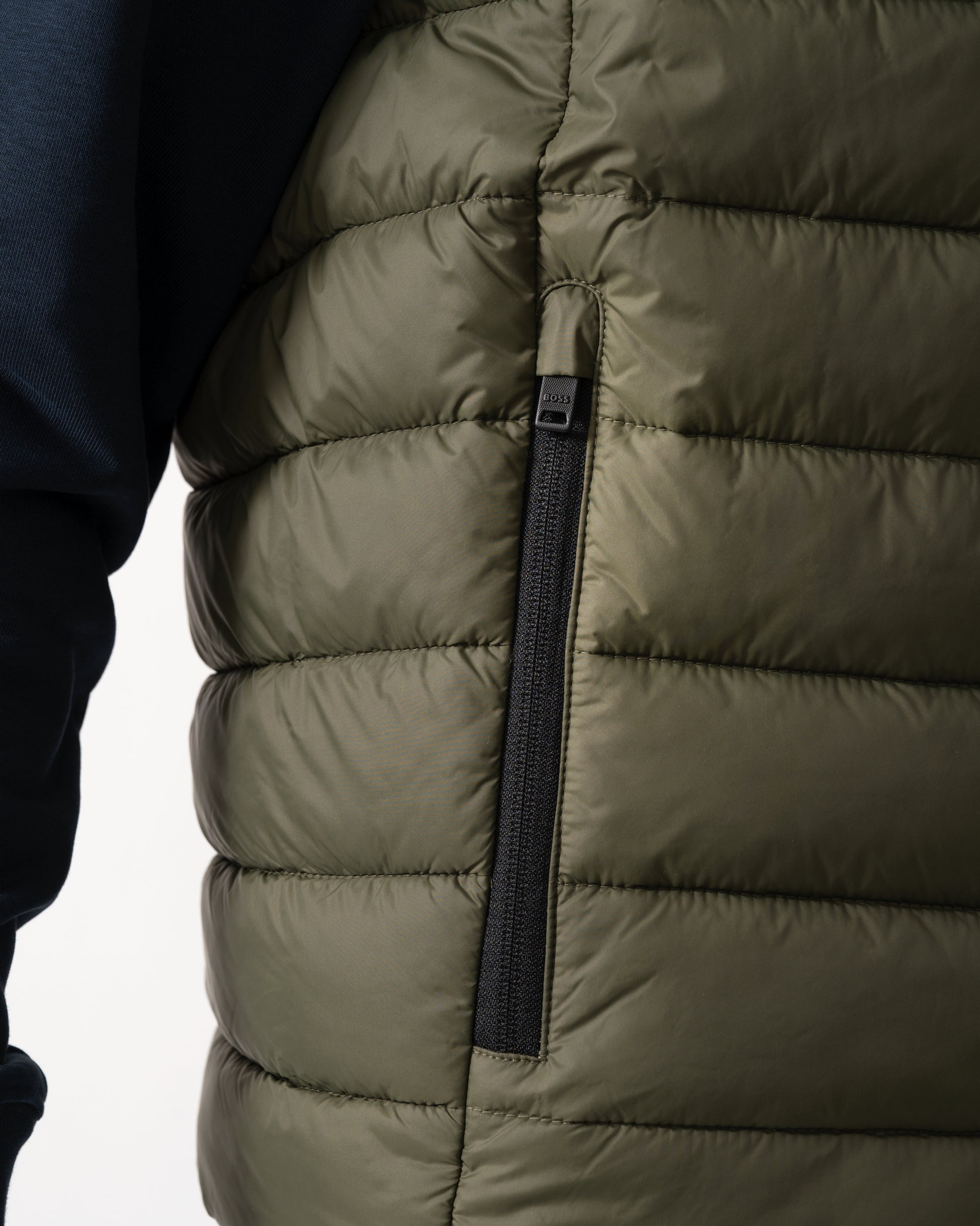 pocket detail shot of a model wearing a BOSS Orange Odeno 2 Mens Gilet in Bright Green 325