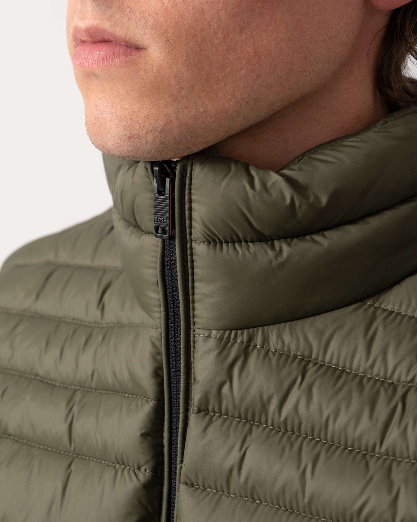 zip detail shot of a model wearing a BOSS Orange Odeno 2 Mens Gilet in Bright Green 325