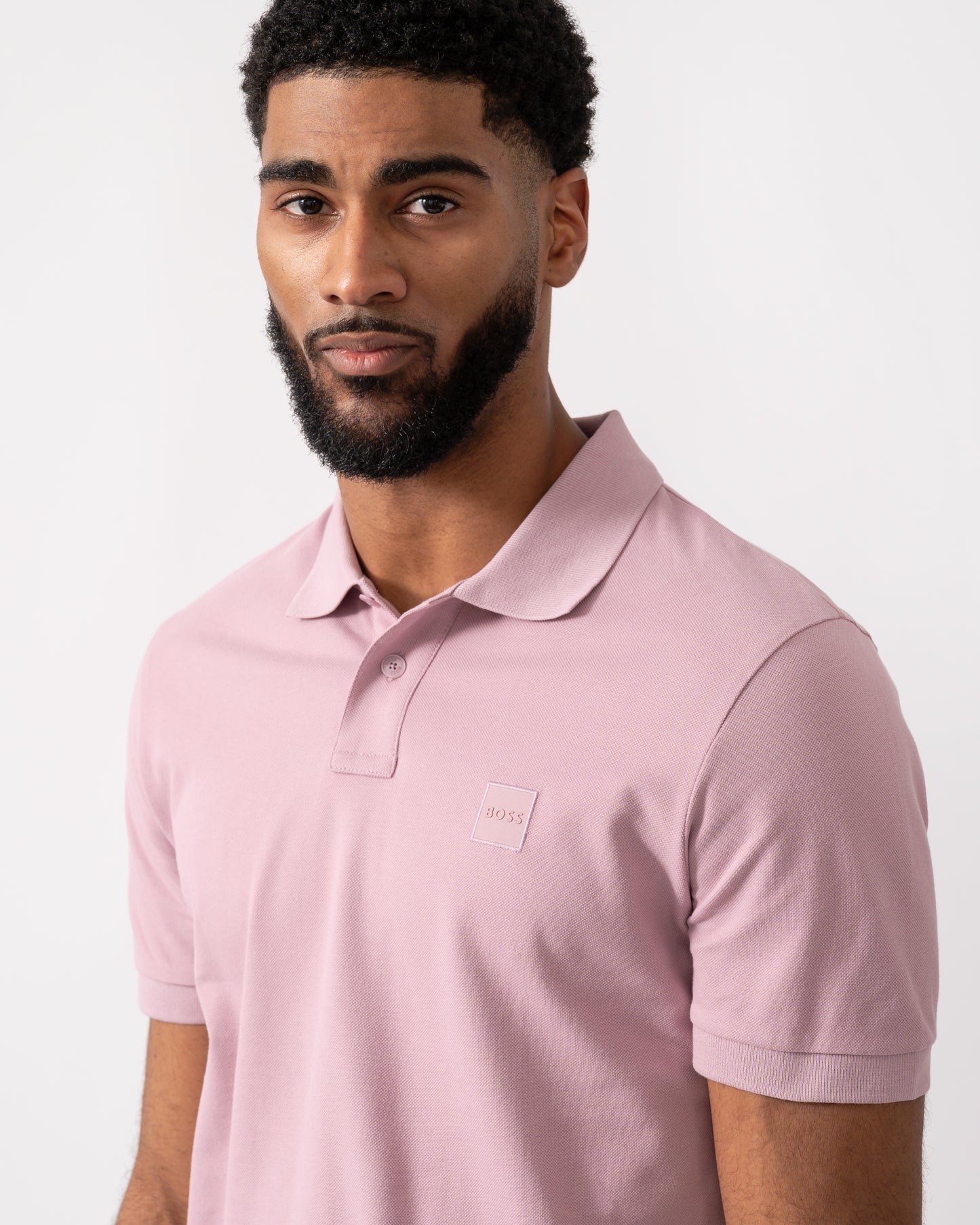 close up of a model wearing a BOSS Orange Passenger Mens Stretch-Cotton Slim-Fit Polo Shirt with Logo Patch in Light/Pastel Purple