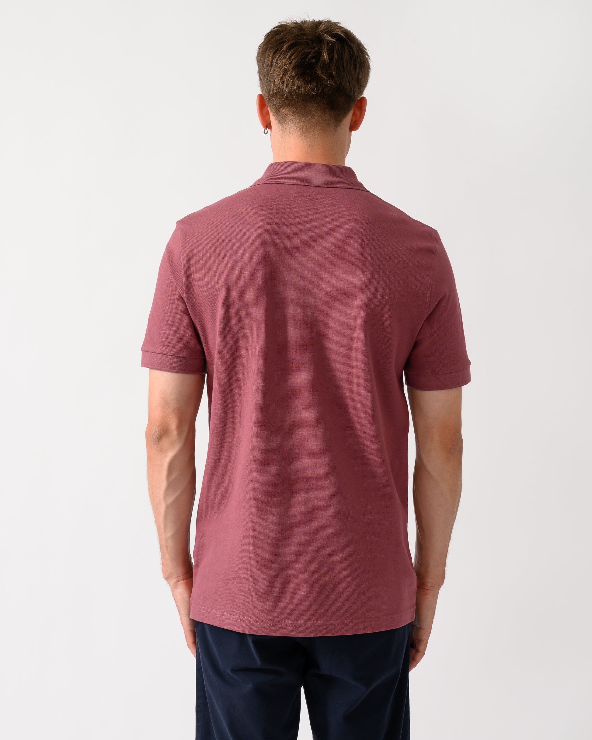 back shot of a model wearing a BOSS Orange Passenger Mens Stretch-Cotton Slim-Fit Polo Shirt with Logo Patch in Medium Red 618