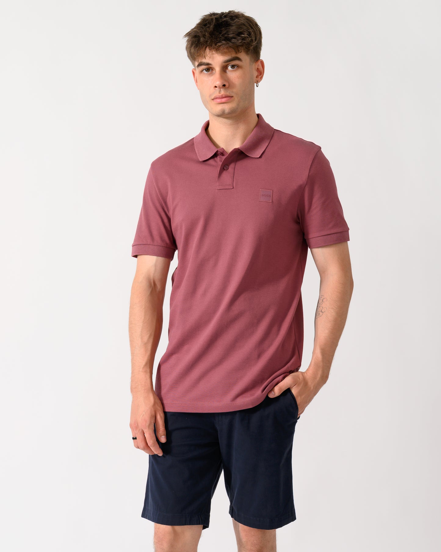 model wearing a BOSS Orange Passenger Mens Stretch-Cotton Slim-Fit Polo Shirt with Logo Patch in Medium Red 618