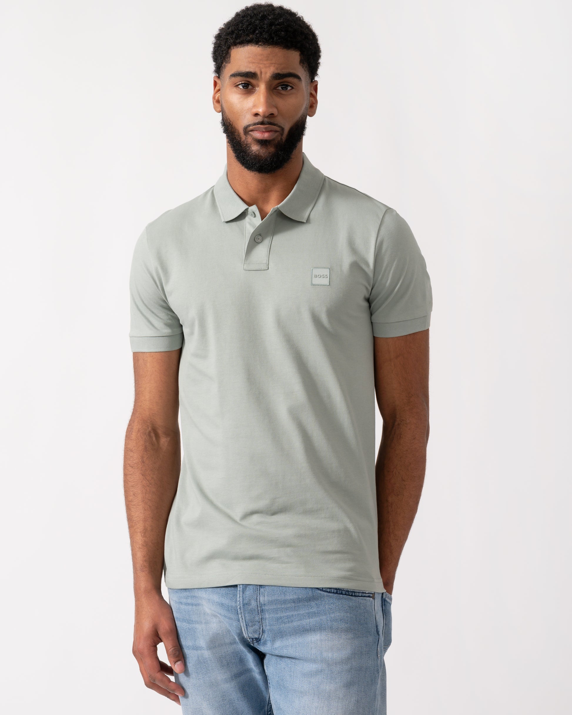 Model wearing a BOSS Orange Passenger Mens Stretch-Cotton Slim-Fit Polo Shirt with Logo Patch in Open Green