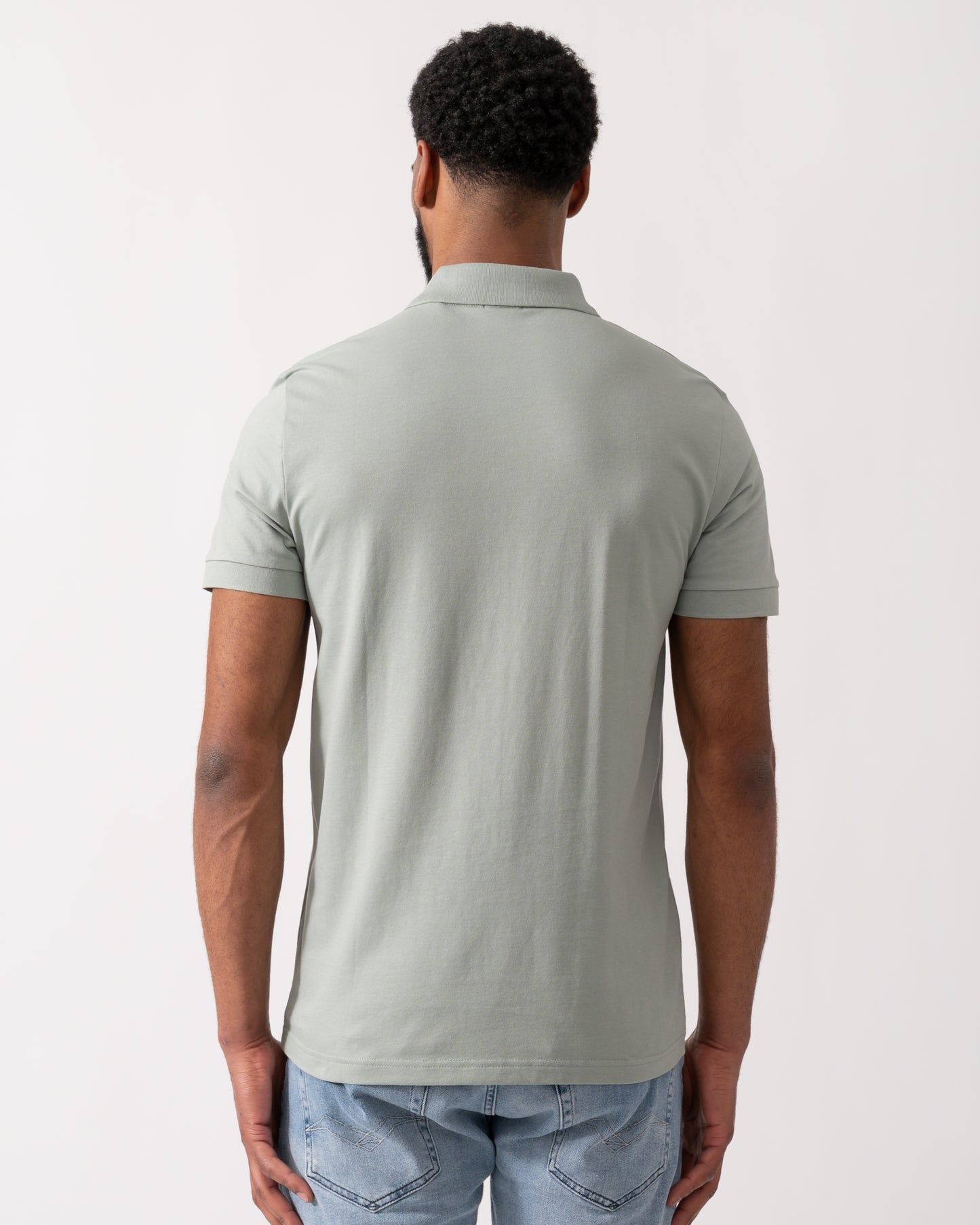 back shot of a Model wearing a BOSS Orange Passenger Mens Stretch-Cotton Slim-Fit Polo Shirt with Logo Patch in Open Green