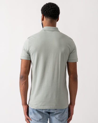 back shot of a Model wearing a BOSS Orange Passenger Mens Stretch-Cotton Slim-Fit Polo Shirt with Logo Patch in Open Green