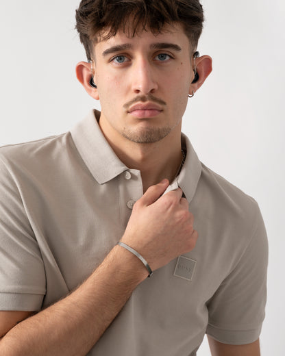 close up shot of a model wearing a BOSS Orange Passenger Mens Stretch-Cotton Slim-Fit Polo Shirt with Logo Patch in Open Grey 070