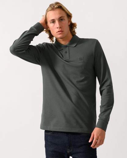 model wearing a BOSS Orange Passerby Mens Long Sleeve Stretch-Cotton Polo Shirt with Logo Patch in Open Green 377