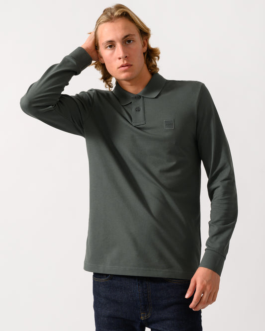 model wearing a BOSS Orange Passerby Mens Long Sleeve Stretch-Cotton Polo Shirt with Logo Patch in Open Green 377