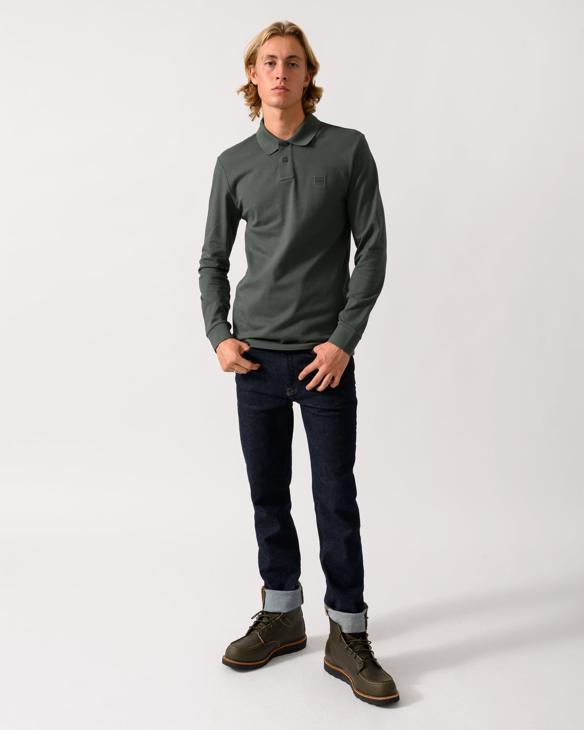 full length of a model wearing a BOSS Orange Passerby Mens Long Sleeve Stretch-Cotton Polo Shirt with Logo Patch in Open Green 377