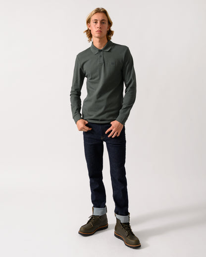 full length of a model wearing a BOSS Orange Passerby Mens Long Sleeve Stretch-Cotton Polo Shirt with Logo Patch in Open Green 377