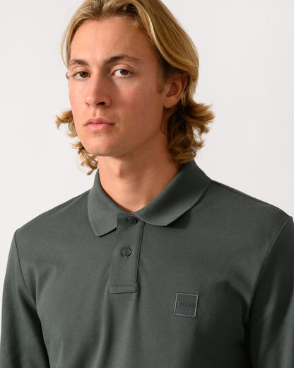 close up of model wearing a BOSS Orange Passerby Mens Long Sleeve Stretch-Cotton Polo Shirt with Logo Patch in Open Green 377